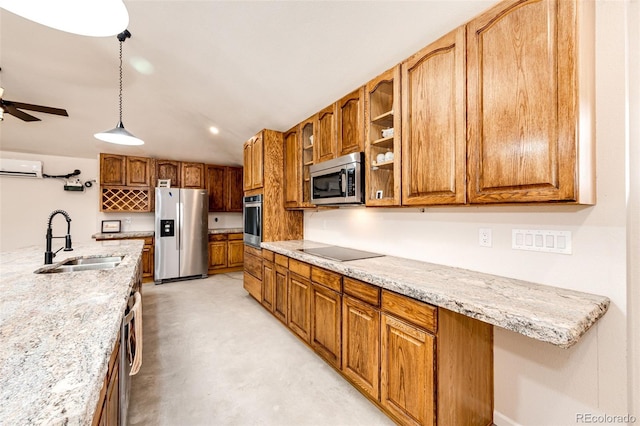 24130 High Timber Ln, Agate, CO 80101 - kitchen featuring stainless steel appliances, a sink, a wall mounted AC, brown cabinetry, and a ceiling fan