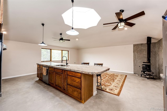 24130 High Timber Ln, Agate, CO 80101 - kitchen with a ceiling fan, stainless steel dishwasher, a sink, light countertops, and a breakfast bar