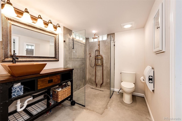 24130 High Timber Ln, Agate, CO 80101 - full bathroom featuring toilet, a walk in shower, unfinished concrete floors, vanity, and baseboards