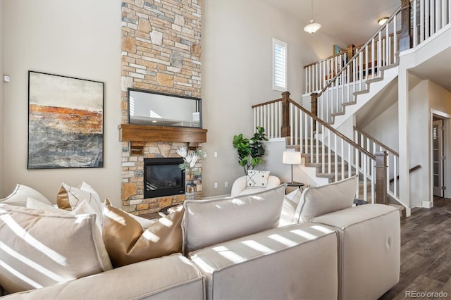 living room featuring a fireplace, dark hardwood / wood-style floors, and a high ceiling