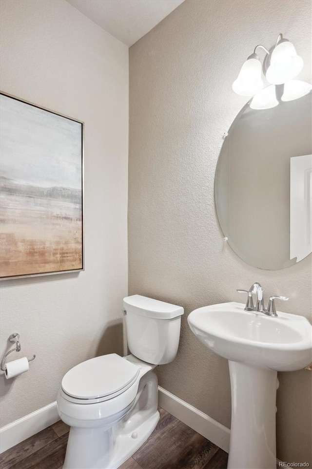 bathroom with wood-type flooring and toilet