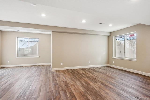 basement with hardwood / wood-style flooring