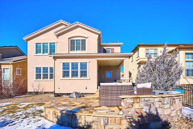 view of snow covered rear of property