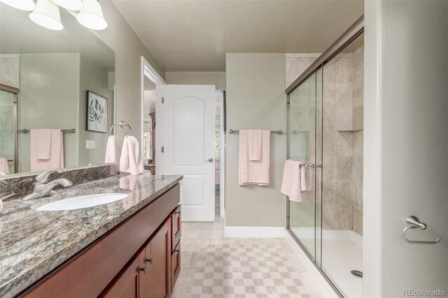 6400 S Ider St, Aurora, CO 80016 - full bathroom featuring vanity, a shower stall, and tile patterned floors