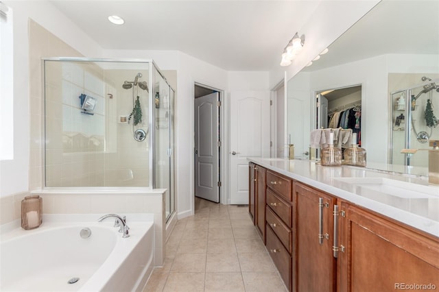 6400 S Ider St, Aurora, CO 80016 - full bath with a shower stall, double vanity, a garden tub, a walk in closet, and tile patterned floors