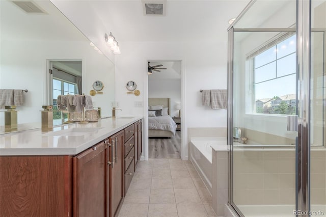 6400 S Ider St, Aurora, CO 80016 - ensuite bathroom with healthy amount of natural light, double vanity, tile patterned floors, and a ceiling fan