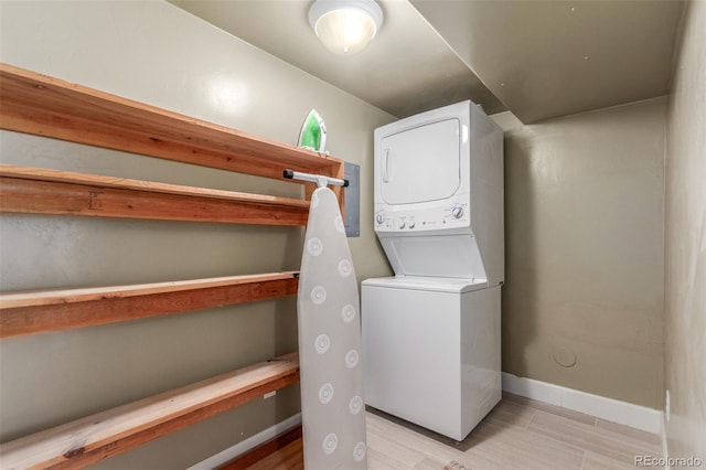 6400 S Ider St, Aurora, CO 80016 - washroom featuring estacked washer and dryer and baseboards