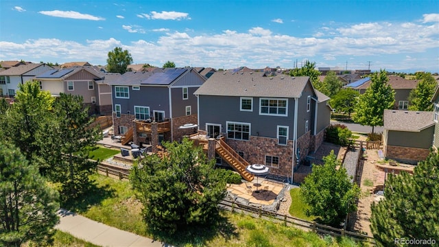 6400 S Ider St, Aurora, CO 80016 - back of house featuring a residential view, stairway, stone siding, a patio area, and a deck