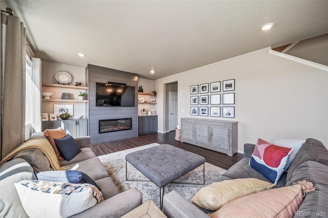 living room with recessed lighting, baseboards, a fireplace, and dark wood-style floors