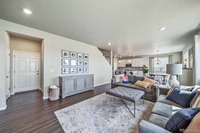 living room featuring recessed lighting, baseboards, and dark wood-type flooring