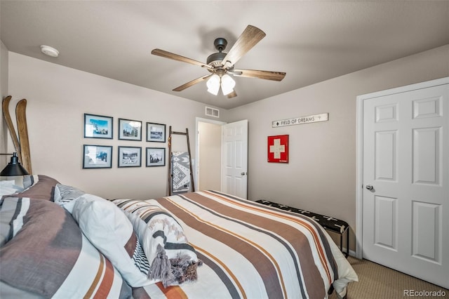 carpeted bedroom featuring ceiling fan and visible vents