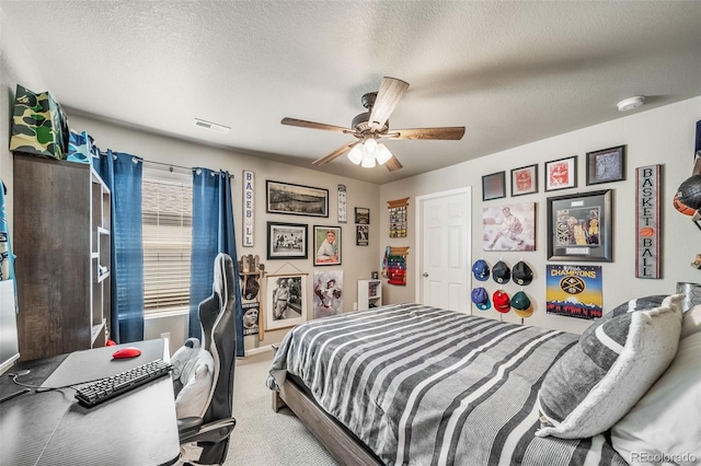 bedroom featuring ceiling fan, light colored carpet, a textured ceiling, baseboards, and visible vents