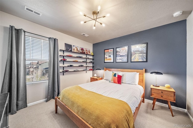 bedroom featuring visible vents, baseboards, light colored carpet, and an inviting chandelier
