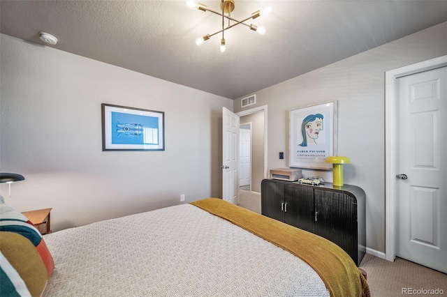 bedroom with visible vents, carpet, and a notable chandelier