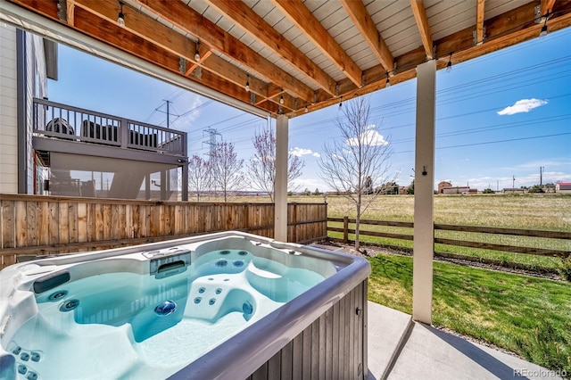 exterior space featuring a hot tub and fence
