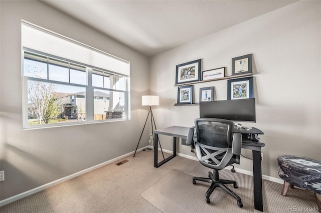 carpeted home office featuring baseboards and visible vents