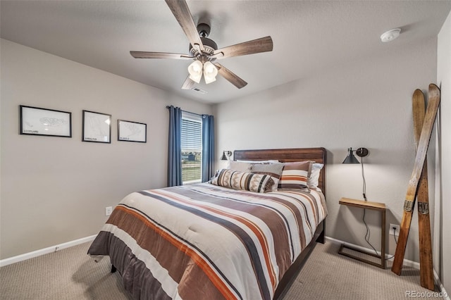 carpeted bedroom featuring baseboards, a ceiling fan, and visible vents