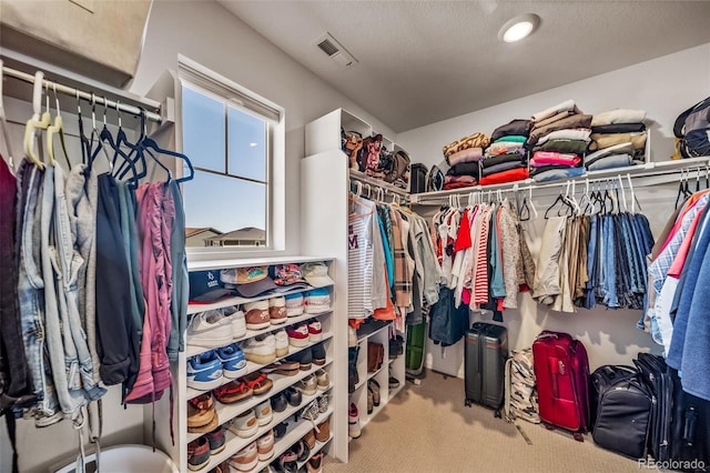 walk in closet featuring carpet flooring and visible vents