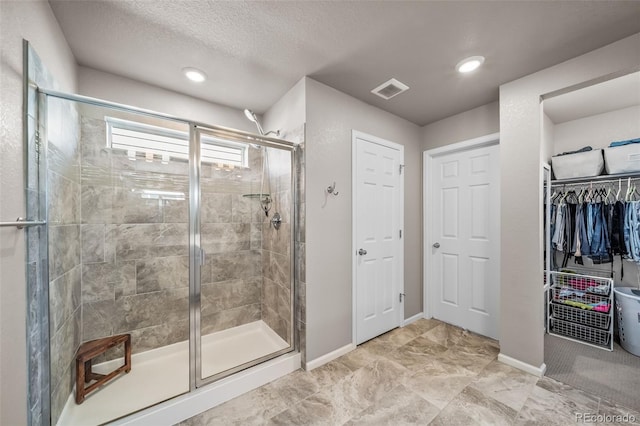 full bathroom with baseboards and a stall shower