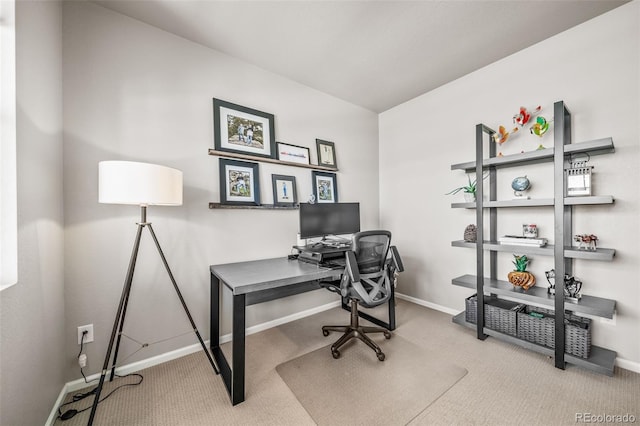 carpeted office featuring baseboards
