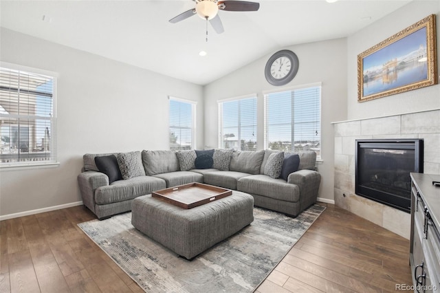 living room with a wealth of natural light, dark wood-type flooring, and vaulted ceiling