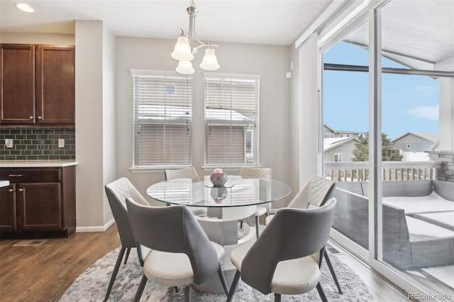 dining area featuring dark wood-type flooring