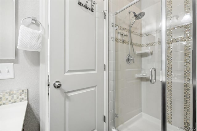 bathroom with a shower with door