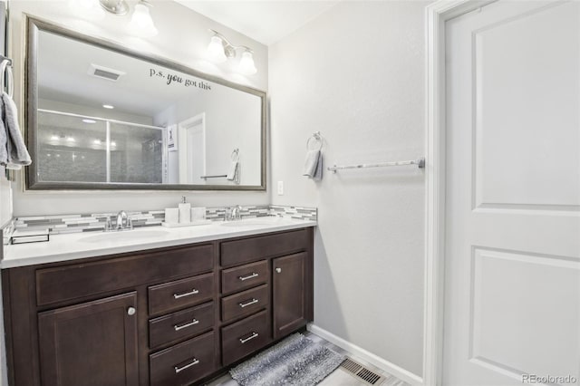 bathroom featuring vanity and a shower with shower door