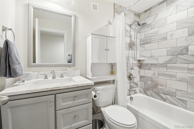 full bathroom with vanity, shower / bath combination with curtain, and toilet