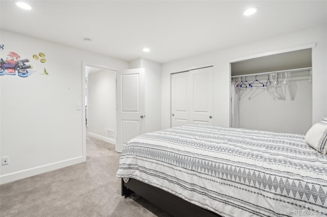 bedroom featuring multiple closets and light colored carpet