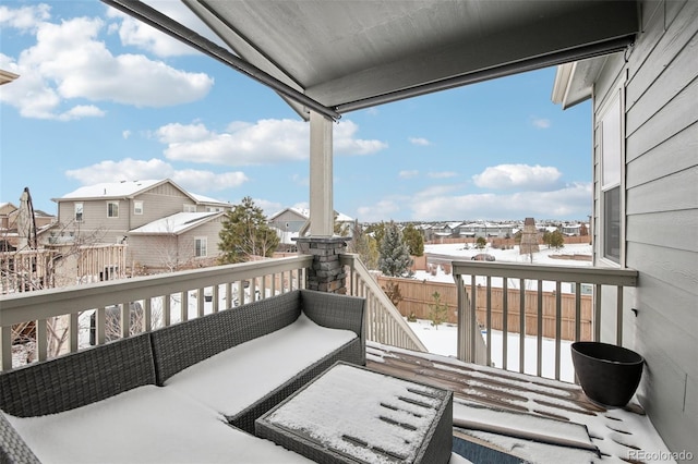 view of snow covered back of property