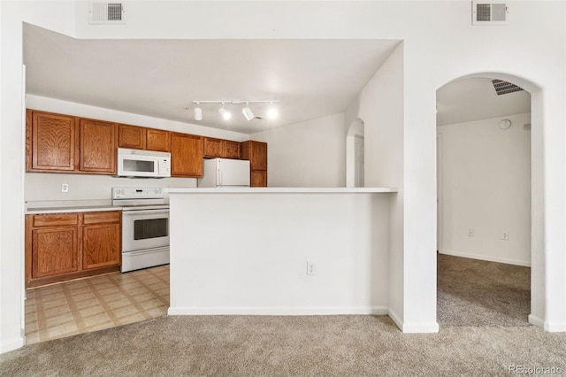 kitchen featuring light carpet and white appliances