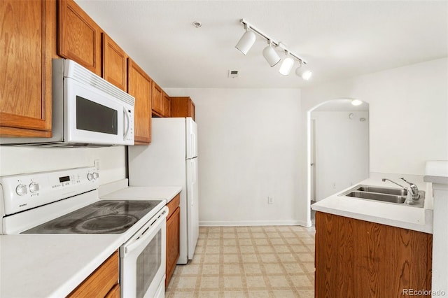 kitchen featuring sink and white appliances