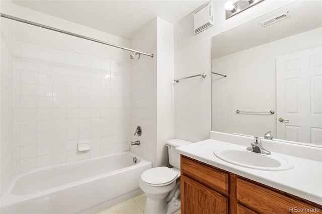 full bathroom featuring vanity, tiled shower / bath, tile patterned floors, and toilet