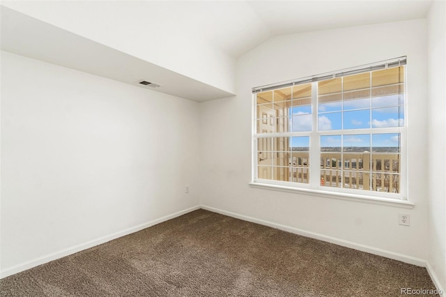 unfurnished room with carpet floors and vaulted ceiling