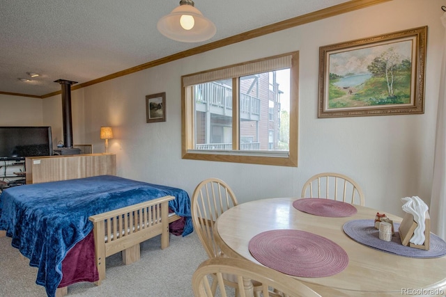 2710 Ryan Gulch Rd Unit 2714, Silverthorne, CO 80498 - bedroom with crown molding, carpet, a wood stove, and a textured ceiling