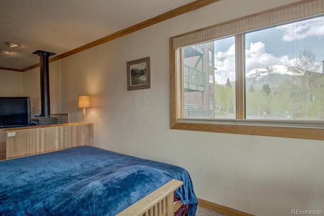 2710 Ryan Gulch Rd Unit 2714, Silverthorne, CO 80498 - carpeted bedroom featuring ornamental molding, a textured wall, a textured ceiling, and a wood stove