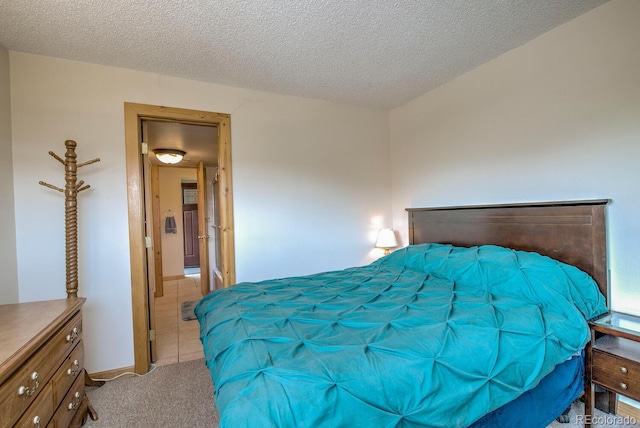 2710 Ryan Gulch Rd Unit 2714, Silverthorne, CO 80498 - bedroom with light tile patterned flooring, light colored carpet, and a textured ceiling