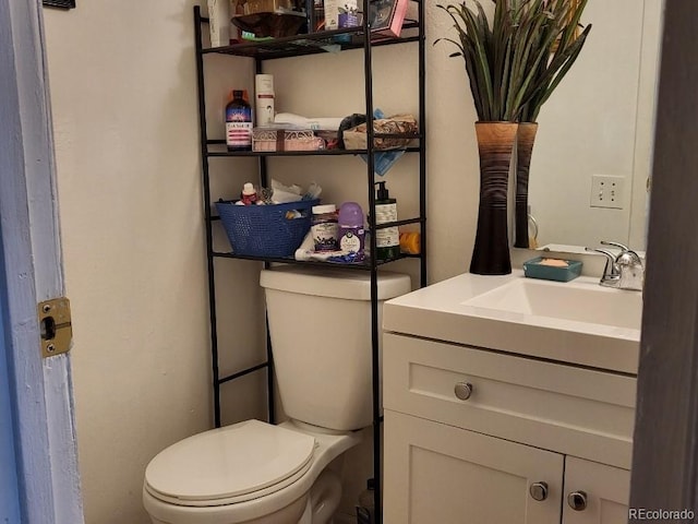 bathroom with toilet and vanity