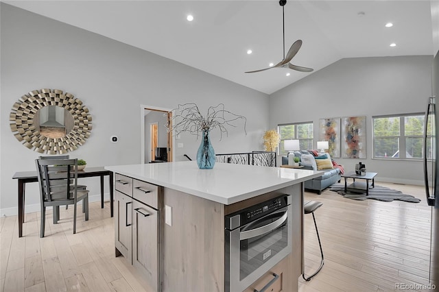 79 Beaver Rd, Idaho Springs, CO 80452 - kitchen featuring ceiling fan, light countertops, a kitchen island, wall oven, and high vaulted ceiling