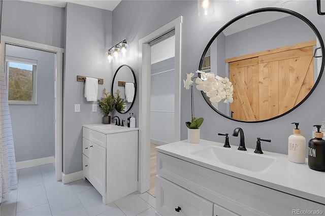 79 Beaver Rd, Idaho Springs, CO 80452 - bathroom featuring two vanities, tile patterned floors, and baseboards