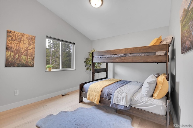 79 Beaver Rd, Idaho Springs, CO 80452 - bedroom with lofted ceiling, wood finished floors, and baseboards