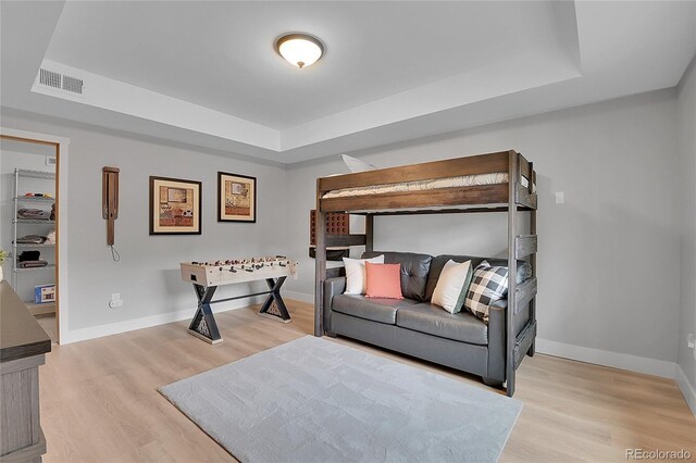 79 Beaver Rd, Idaho Springs, CO 80452 - bedroom with a raised ceiling, light wood-type flooring, and baseboards