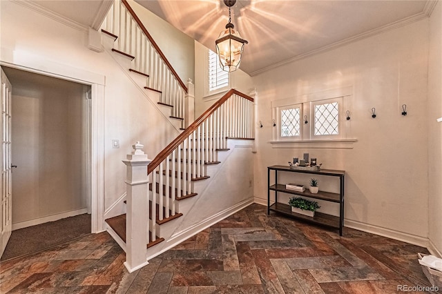 stairway featuring an inviting chandelier, crown molding, and baseboards