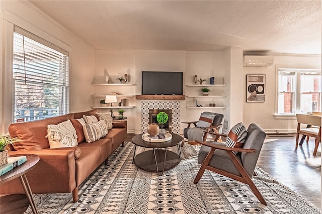 living room featuring ornamental molding, plenty of natural light, and a wall mounted AC