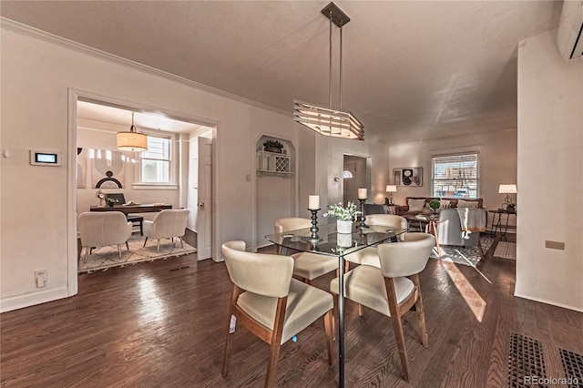 dining space with dark wood-style floors, a wealth of natural light, and ornamental molding