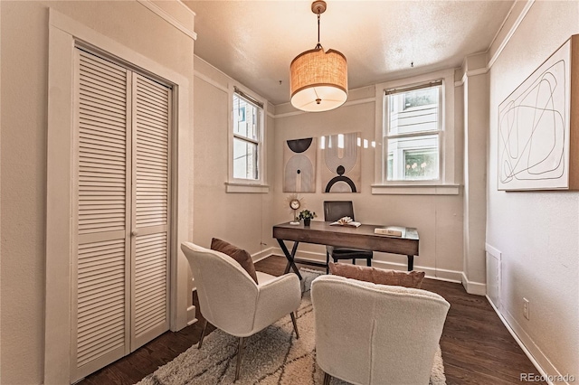 office space featuring dark wood-style floors, plenty of natural light, and baseboards