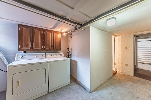 washroom with cabinet space and washer and clothes dryer