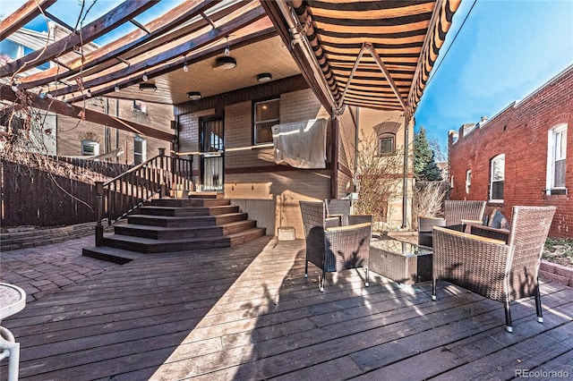 wooden deck featuring fence and a pergola