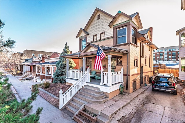 view of front of house with a porch and brick siding